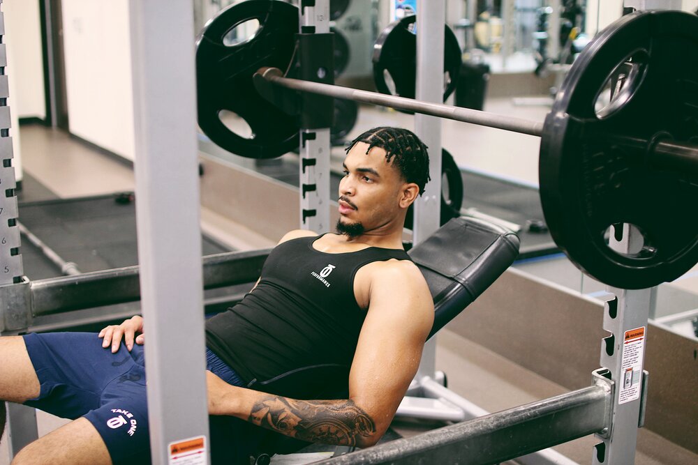 T1 Performance Tank top designed for high-intensity training with moisture-wicking fabric, breathable mesh panels, and athletic cut