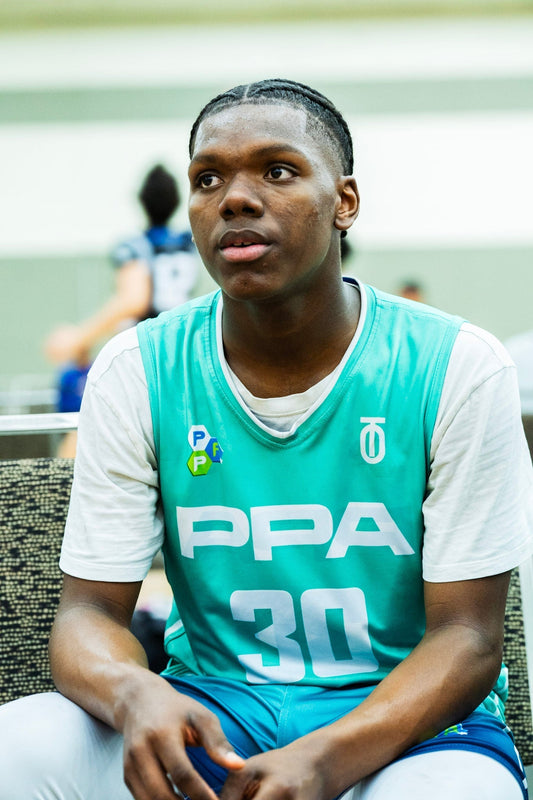 PPA Premier Hoops basketball player seated courtside wearing a turquoise number 30 jersey with the Take One Sportswear logo.