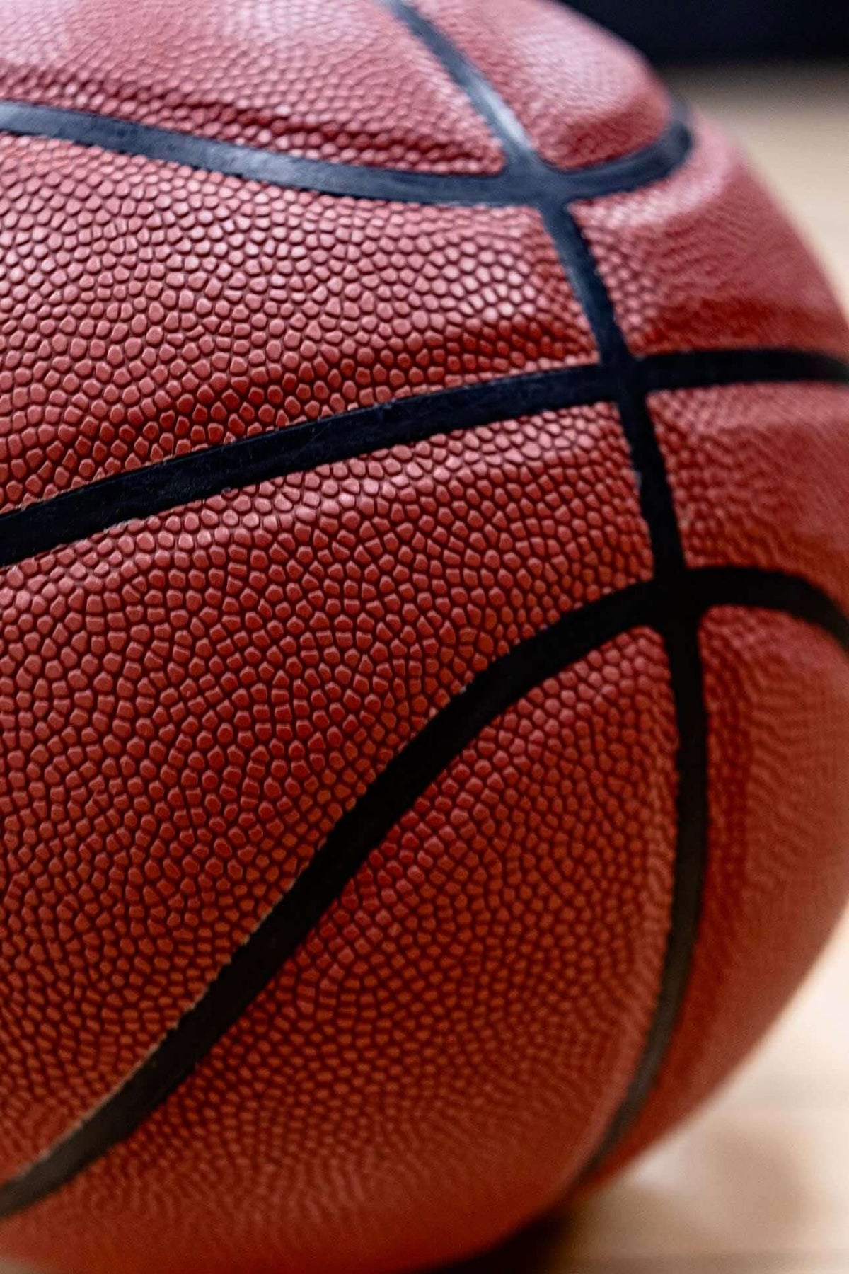 Close-up of the textured surface, black channels, and panel detailing on the Take One EXCL Basketball.