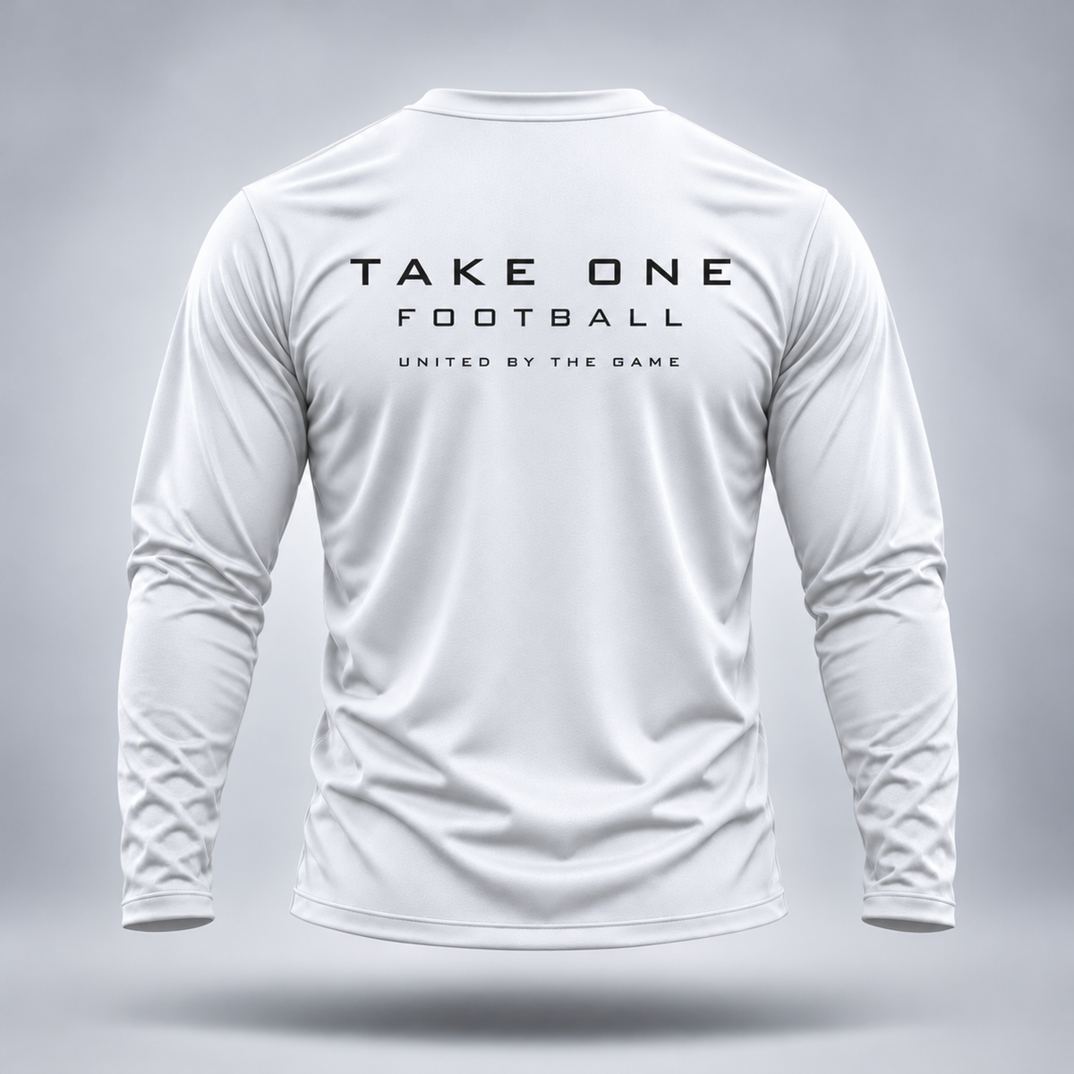Take One Sportswear Football Long Sleeve Performance Tee in white, back view featuring black TAKE ONE FOOTBALL lettering and United By The Game graphic.