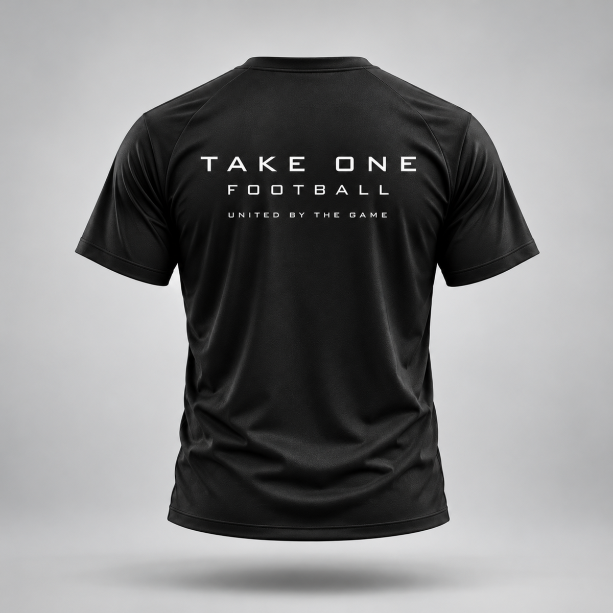 Take One Sportswear black Football Performance Tee back view featuring TAKE ONE FOOTBALL and United By The Game graphics
