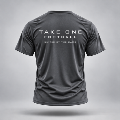 Take One Sportswear graphite gray Football Performance Tee, back view featuring white TAKE ONE FOOTBALL lettering and United By The Game graphic.