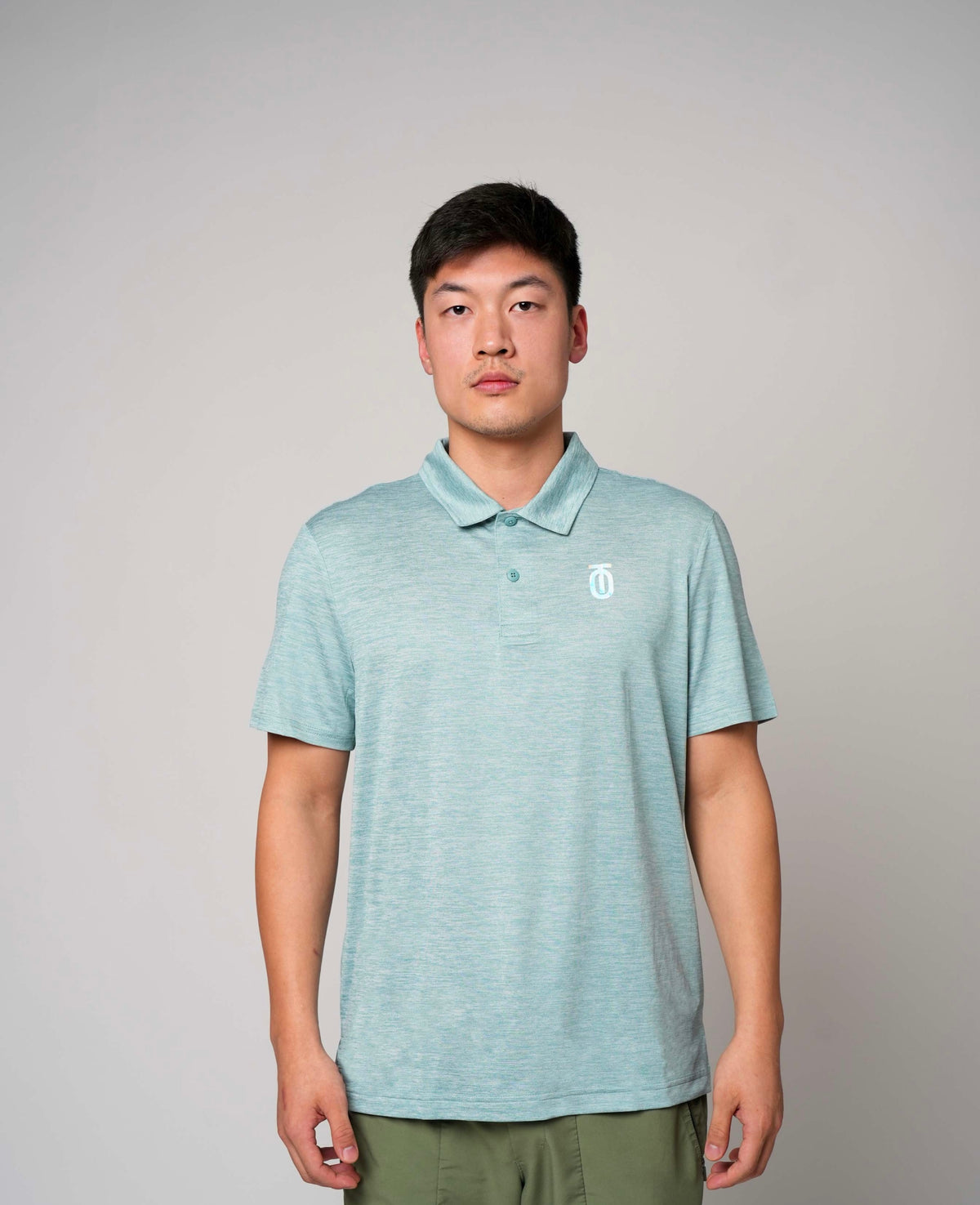 Front view of light blue Take One Journey Performance Polo worn by a male model, featuring a collar and subtle chest branding.
