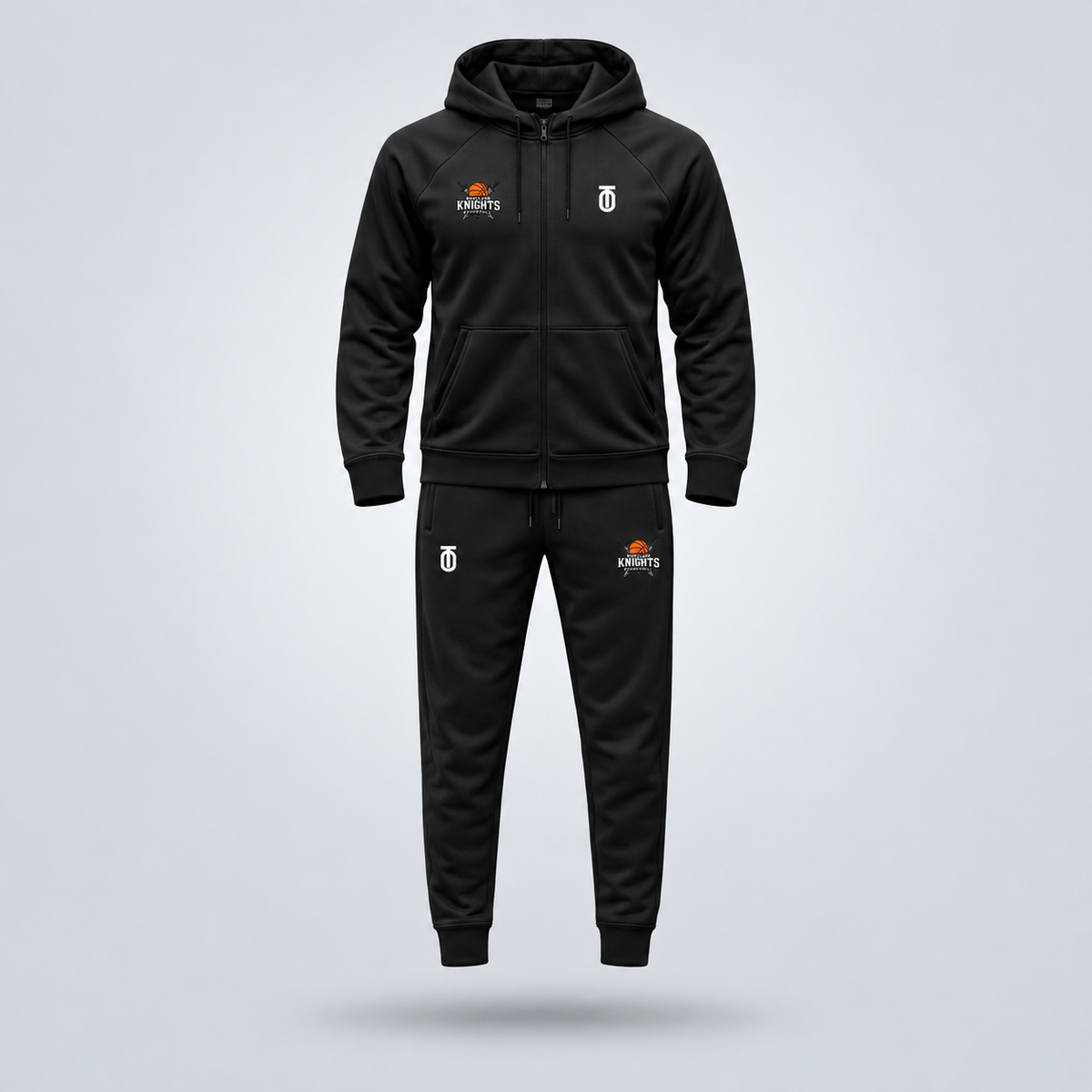 Black Maryland Knights Basketball travel sweatsuit by Take One Sportswear featuring a full-zip hooded jacket and matching joggers with team logos. Neutral grey studio background with a subtle floating shadow.