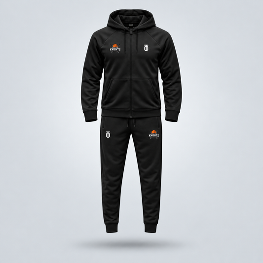 Black Maryland Knights Basketball travel sweatsuit by Take One Sportswear featuring a full-zip hooded jacket and matching joggers with team logos. Neutral grey studio background with a subtle floating shadow.