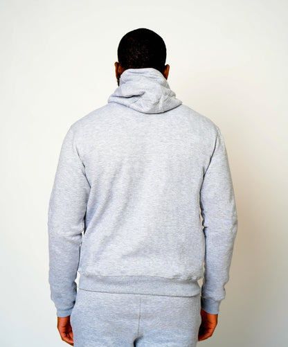 Back view of light grey Take One PeakPro Fleece Pullover worn by a male model, showing the hood and full-length sleeves.