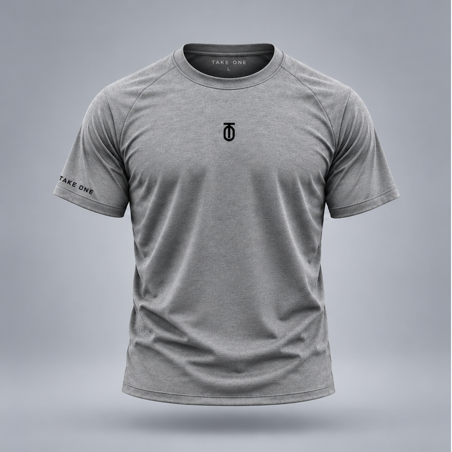 Take One Sportswear Performance Tee in heather grey, front view featuring a black centered TO monogram, TAKE ONE sleeve branding, and athletic fit.